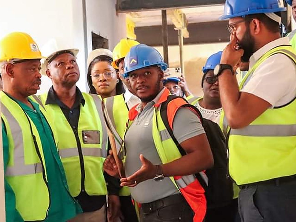 A site crew on a walkthrough in hard hats and high visibility vests