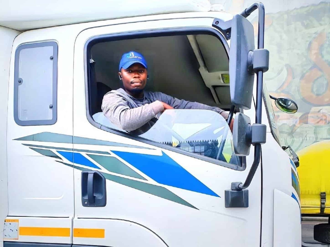 A driver resting in the cab of his truck